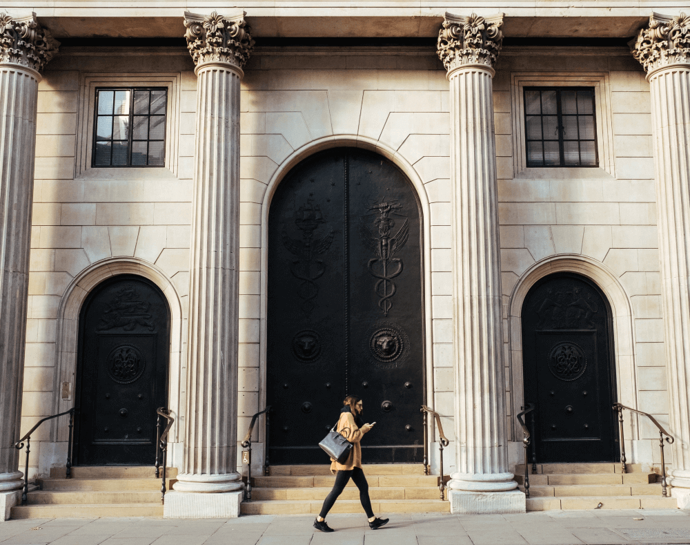 Girl walking in front of a large banking institution